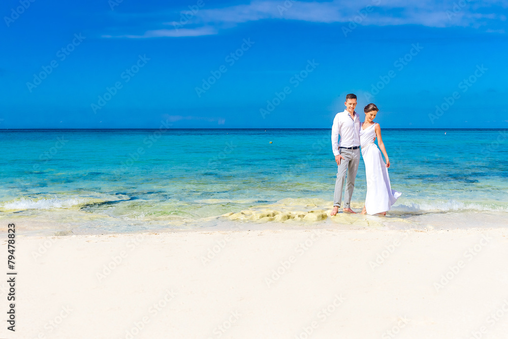 young loving couple on their wedding day, outdoor beach wedding young loving couple on their wedding day, outdoor beach wedding