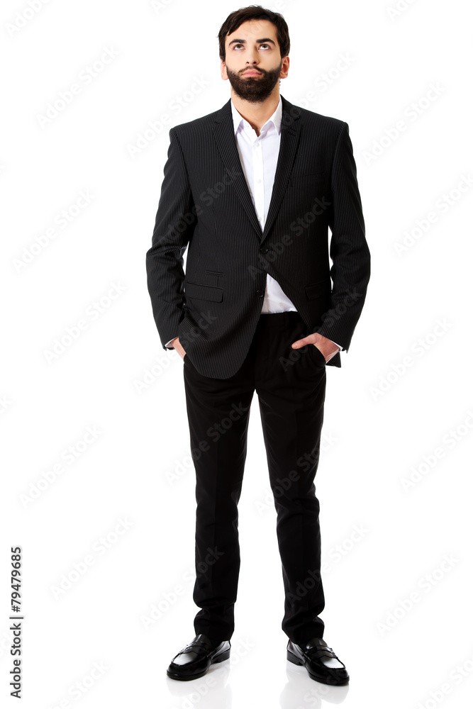 Thoughtful businessman with hands in pockets. Thoughtful businessman with hands in pockets.