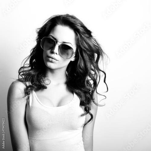 Beautiful teen girl with sun glasses. Fashion girl. Black and wh