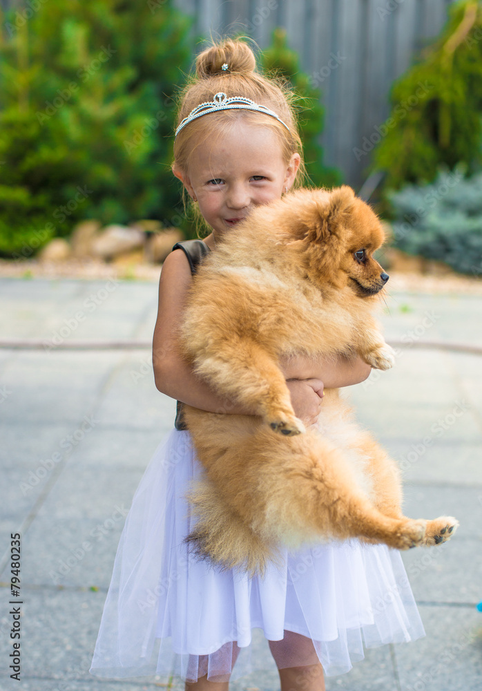 Little blond girl with her pet dog outdoors in park Little blond girl with her pet dog outdoors in park