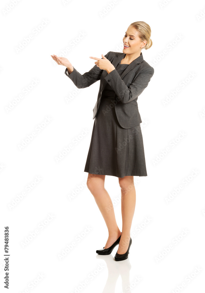 Business woman showing copy space on the left Business woman showing copy space on the left
