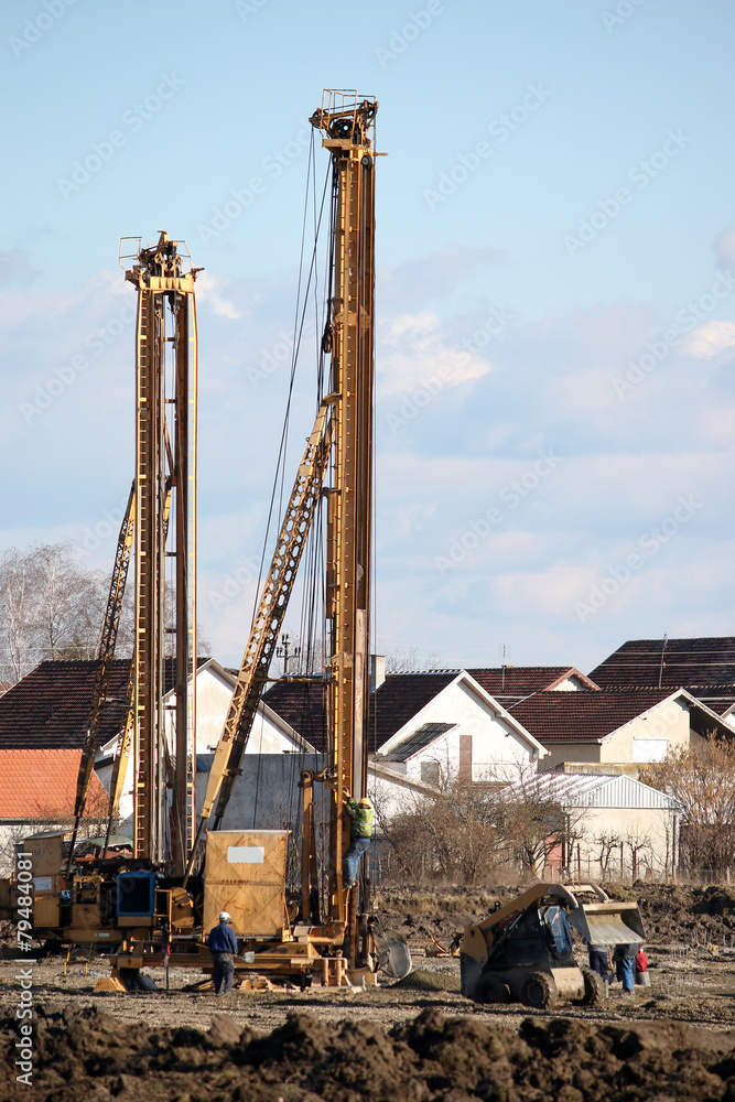 construction site with workers and hydraulic drilling machines construction site with workers and hydraulic drilling machines