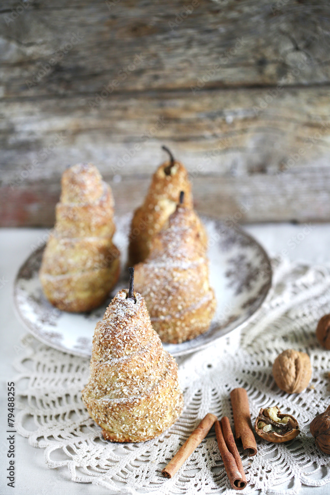 Fototapeta premium Puff pastry pears baked with cinnamon, sesame and walnuts
