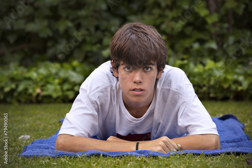 Teenager, with acne knocked down in the grass © fresnel6