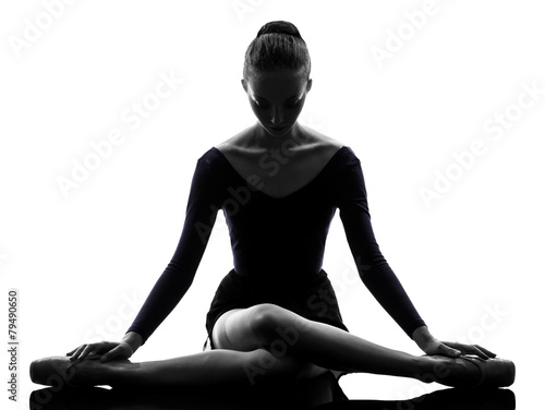 young woman ballerina ballet dancer stretching warming up  silho photo