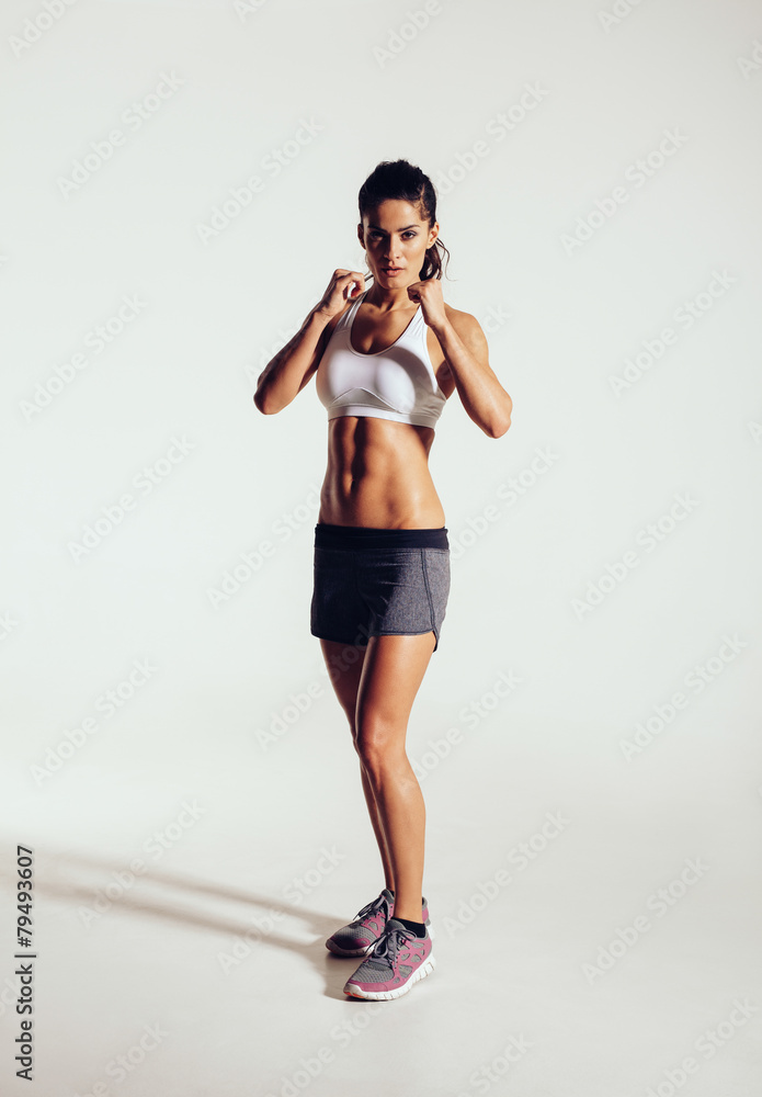Strong young woman doing boxing exercising in studio Strong young woman doing boxing exercising in studio
