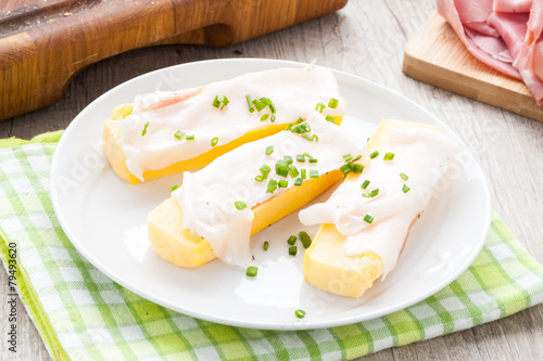 Crostoni di polenta gialla con fettine di  lardo photo