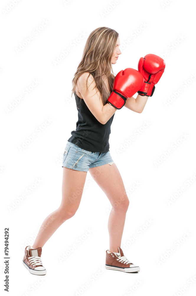 Side view of a female wearing red boxing gloves Side view of a female wearing red boxing gloves