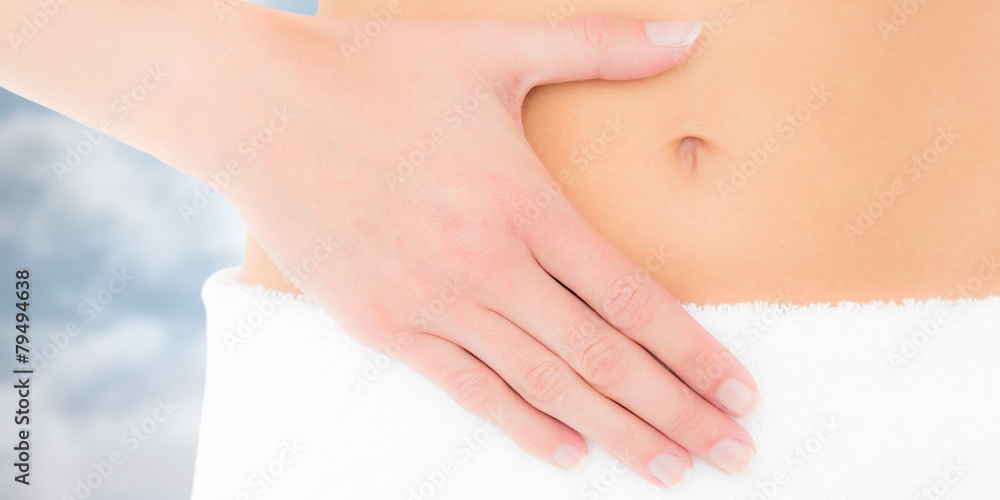 Fit woman with hand on stomach Fit woman with hand on stomach