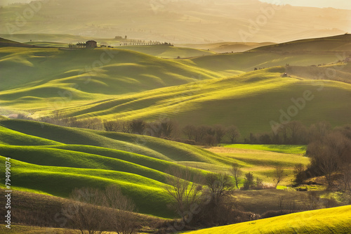 Spring wonderful landscape of Tuscany, green fields, sunrise and