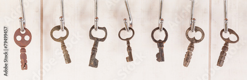 Bunch of old keys hanging on wall © trofimov_pavel