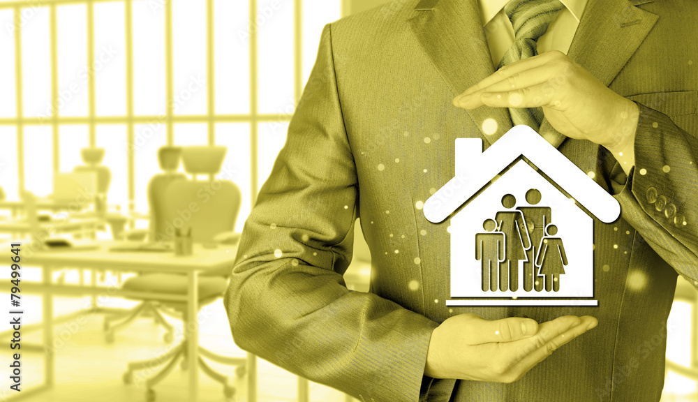 businessman protecting family in home with hands businessman protecting family in home with hands