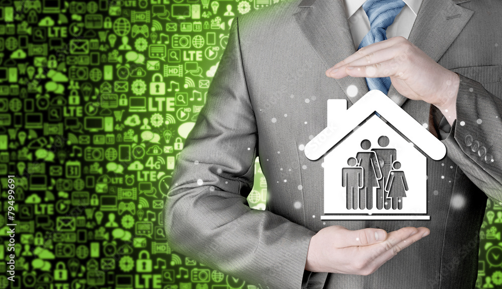 businessman protecting family in home with hands businessman protecting family in home with hands