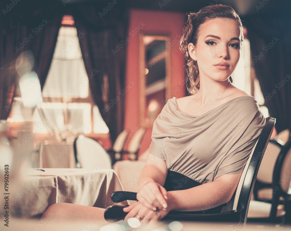 Beautiful young girl in luxury restaurant interior Stock Photo | Adobe ...