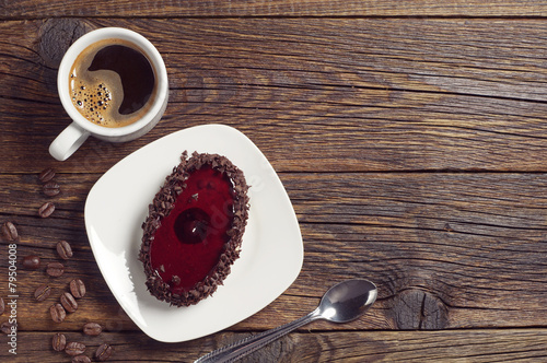 Coffee cup and cake with cherry jelly
