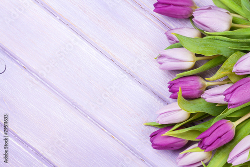 Fototapeta Naklejka Na Ścianę i Meble -  Purple tulips over wooden table