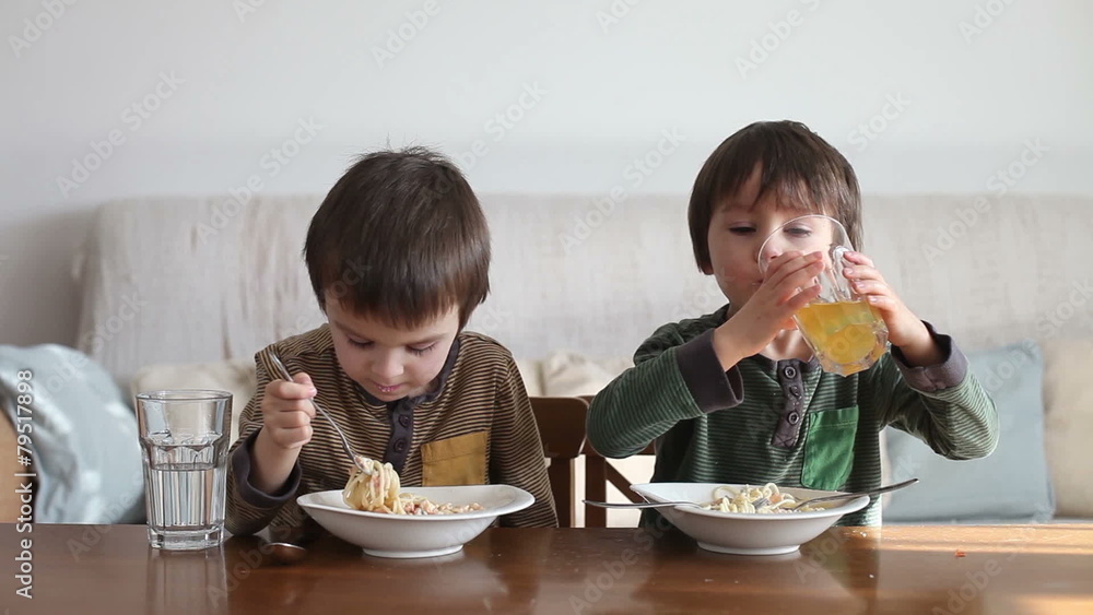 Adorable little boy, eating spaghetti at home, homemade pasta Adorable little boy, eating spaghetti at home, homemade pasta