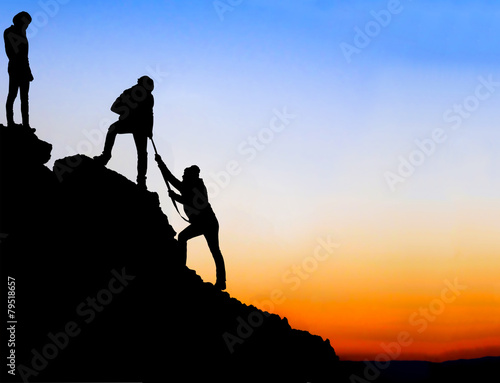 Silhouette of helping hand between two climber © osmanpek