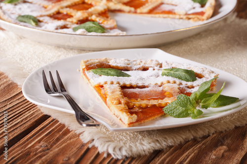 Slice of Italian tart with apricot close-up. Horizontal