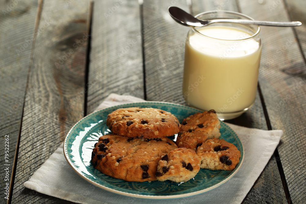 Cookies on plate with jar of condensed milk on wooden Cookies on plate with jar of condensed milk on wooden