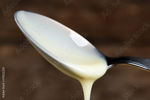 Spoon with condensed milk close up