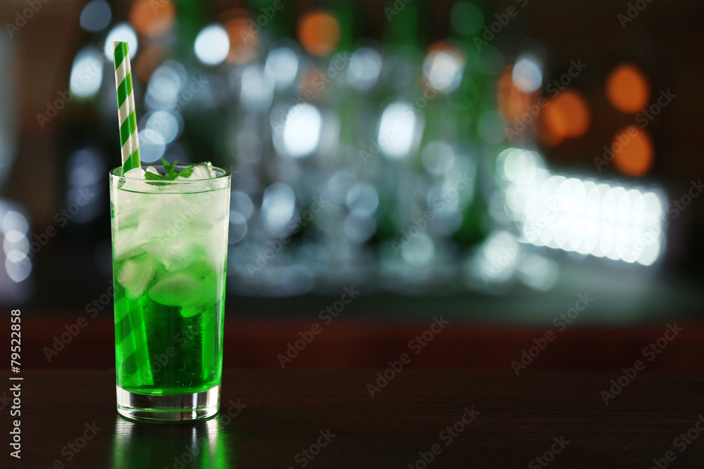 Green cocktail on table on dark background Green cocktail on table on dark background