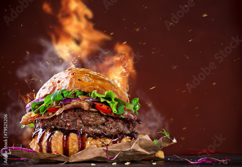 Delicious burger with fire ...