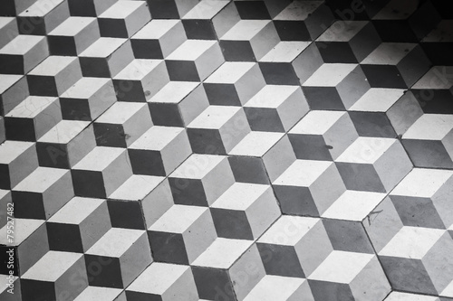 Fototapeta Naklejka Na Ścianę i Meble -  Old black and white tiling on the floor, cubic pattern