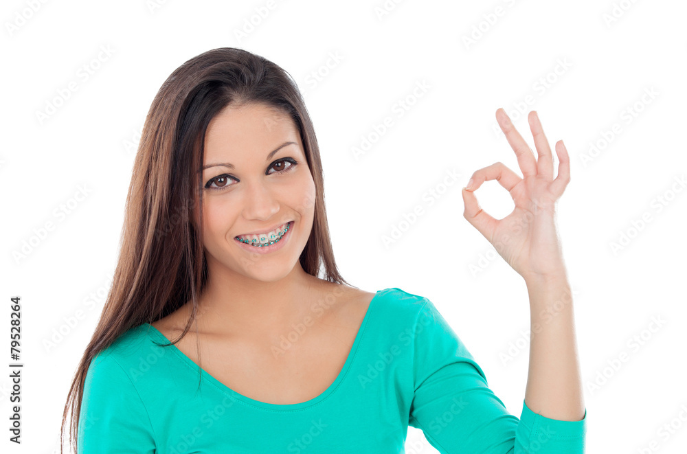 Smiling teenager girl with brackets saying Ok Smiling teenager girl with brackets saying Ok