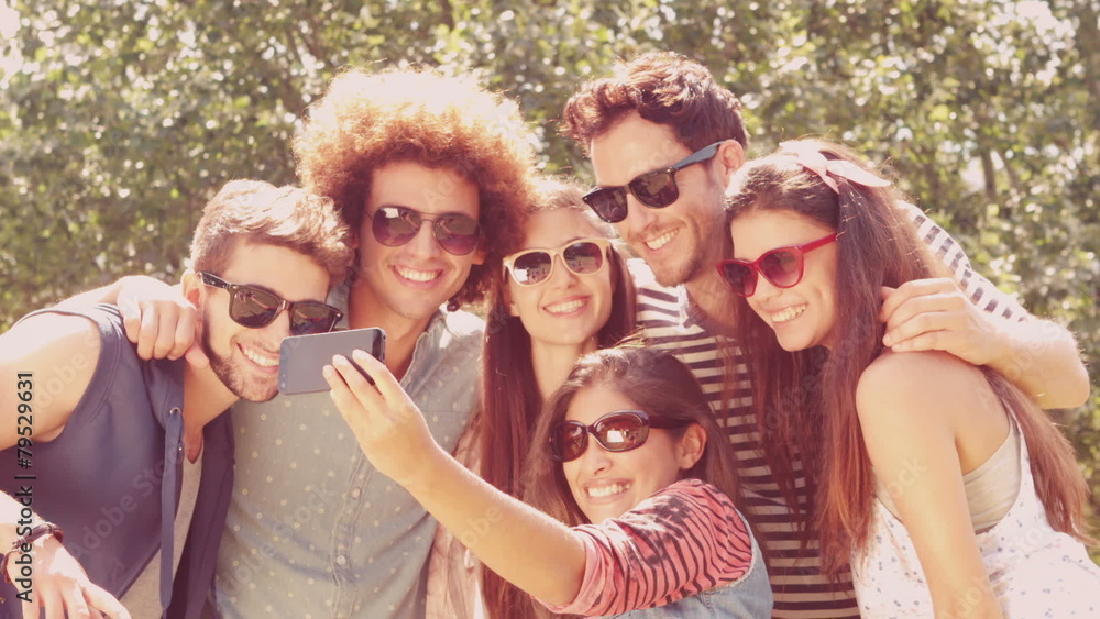 In slow motion happy friends in the park taking selfie In slow motion happy friends in the park taking selfie