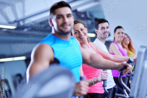 Group of people running on treadmills