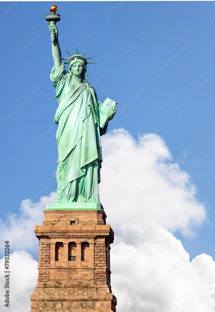 Fototapeta premium Statue of Liberty against blue sky and dramatic clouds