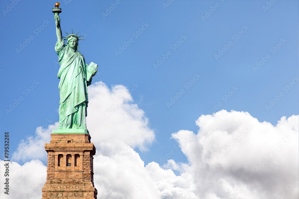 Fototapeta premium Statue of Liberty against blue sky and dramatic clouds