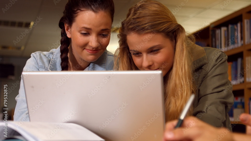 Students working together in the library Students working together in the library