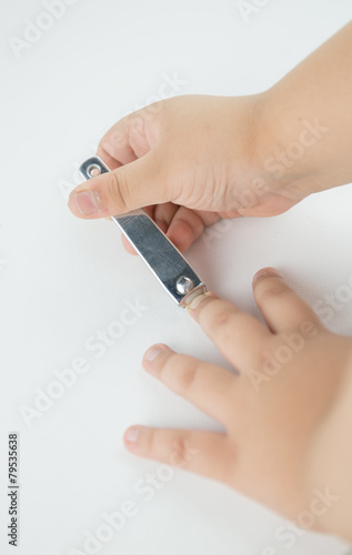 Little hand cutting his fingernail