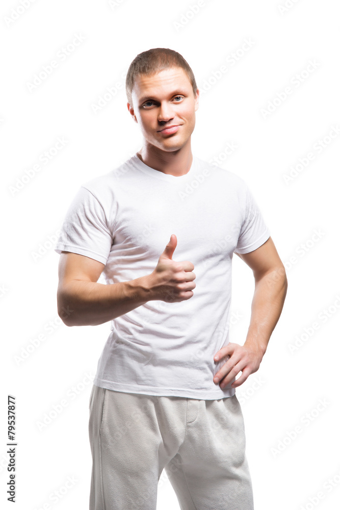 Obraz premium Strong and fit man in white sporty clothes holding thumbs up