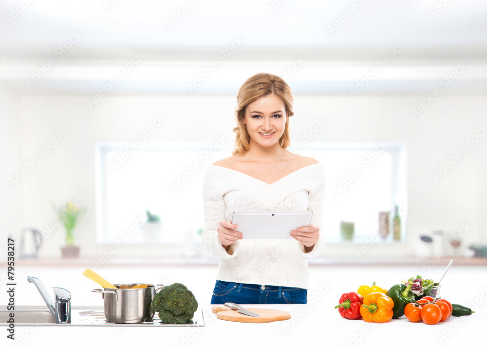Young and beautiful housewife woman cooking in the kitchen