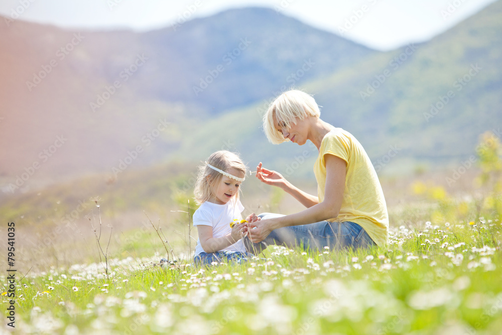 Fototapeta premium Happy woman with a child resting on the nature