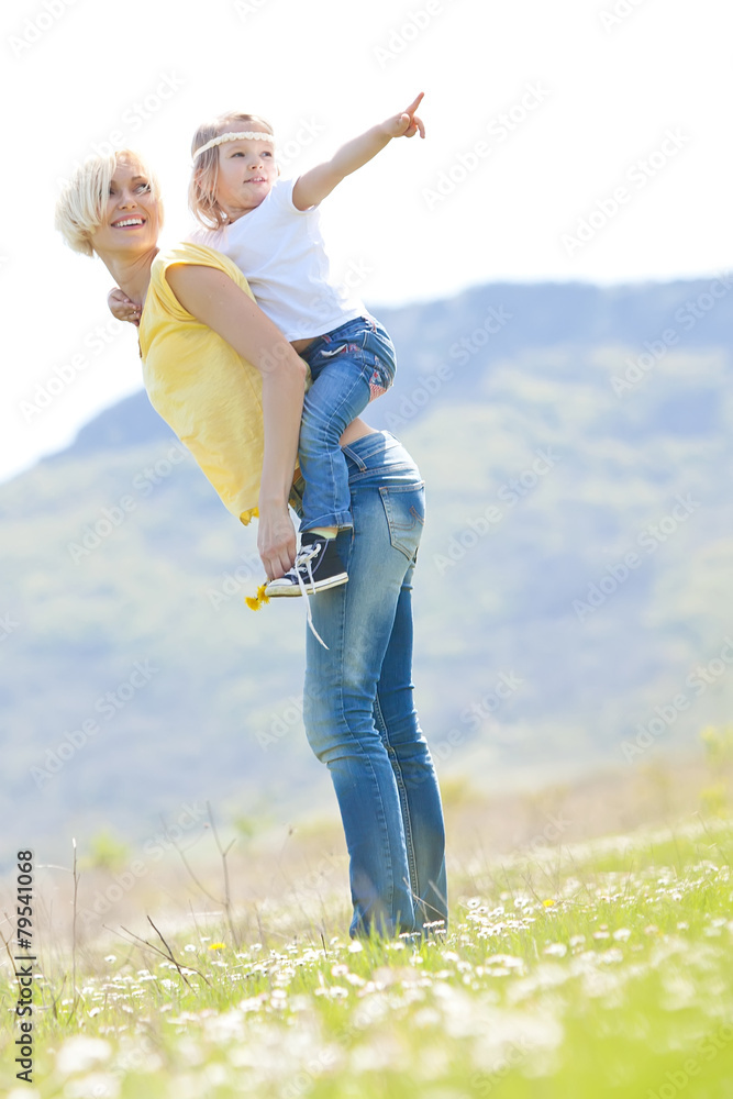 Happy woman with a child resting on the nature Happy woman with a child resting on the nature