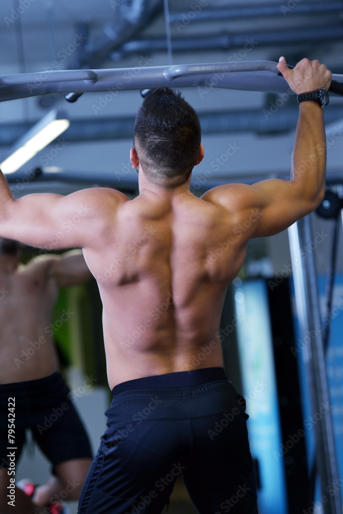 handsome man exercising at the gym handsome man exercising at the gym