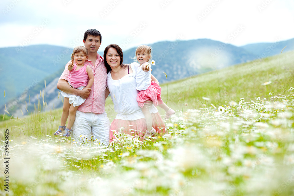 Happy young family in flowers field Happy young family in flowers field