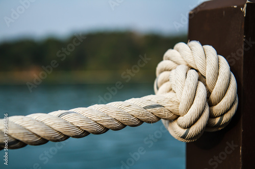 White rope tied into a knot. © photonewman