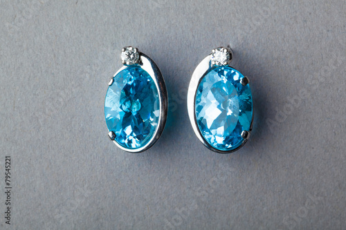 blue sapphire earrings on grey background
