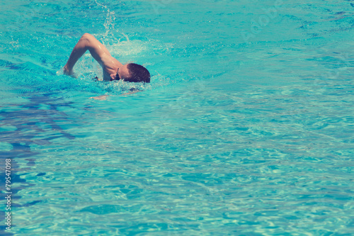 Slim sportsman swimming.