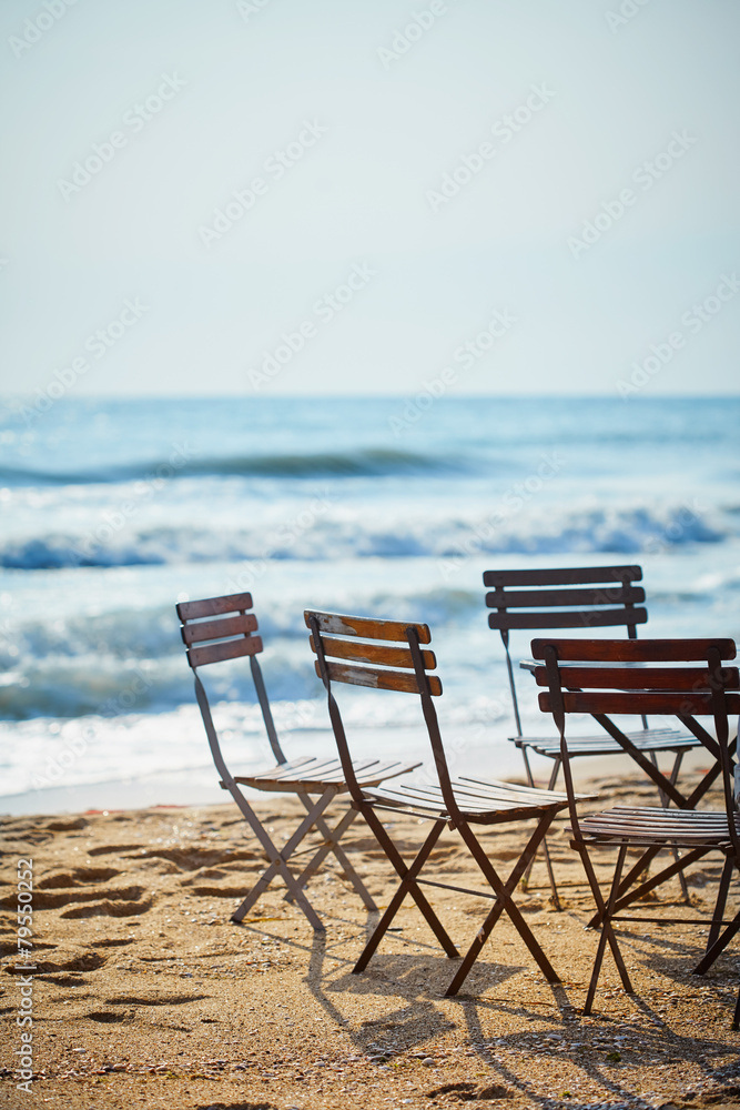 Chairs in sidewalk cafe on beach