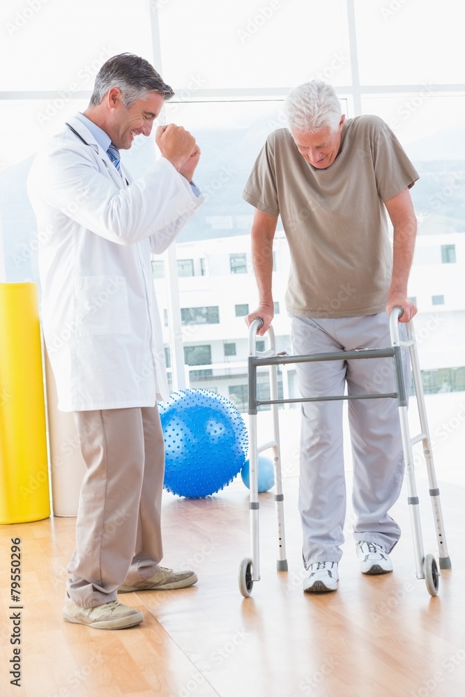 Senior man on zimmer frame with therapist Senior man on zimmer frame with therapist