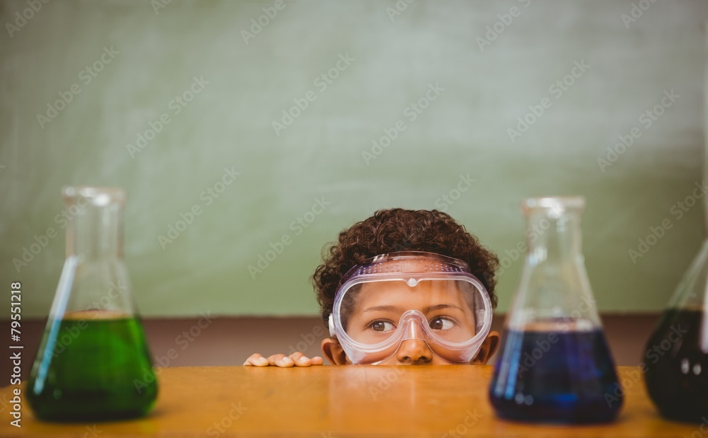 Fotografie Boy looking at conical flasks in classroom