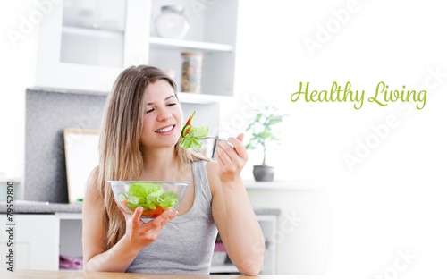 Healthy living against charming woman eating a salad