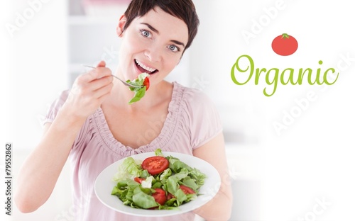 Organic against goodlooking woman eating salad
