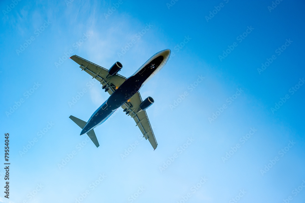 airplane in the blue cloudless sky is landing airplane in the blue cloudless sky is landing
